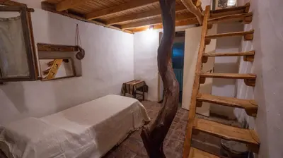 a bedroom with a bunk bed and a ladder at Cosmoqui Casa Boutique in Villa de Las Rosas