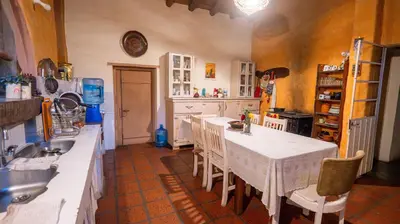 a kitchen with a table and chairs and a sink at Cosmoqui Casa Boutique in Villa de Las Rosas