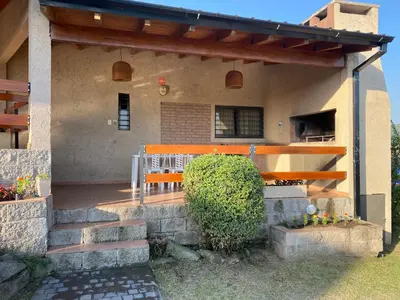a porch of a house with a bench on it at Casa con vista a las Sierras y pileta privada in San Antonio de Arredondo