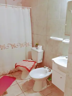 a bathroom with a toilet and a sink at Cabañas Sprinter in Trapiche