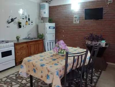 a kitchen with a table with a table cloth on it at Cabañas Sprinter in Trapiche