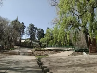 a park with trees and a fence and a sidewalk at Cabañas Sprinter in Trapiche