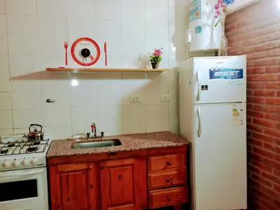 a kitchen with a sink and a white refrigerator at Cabañas Sprinter in Trapiche
