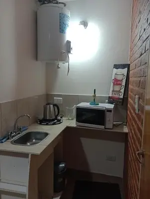 a kitchen with a sink and a microwave on a counter at Cabañas Sprinter in Trapiche