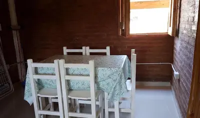 a table and chairs in a room with a window at La Fortaleza in Bialet Massé
