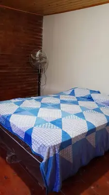 a blue and white quilt on a bed in a room at La Fortaleza in Bialet Massé