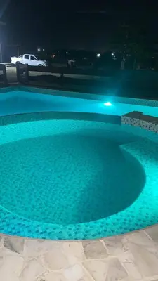 a swimming pool at night with blue lights at La Fortaleza in Bialet Massé
