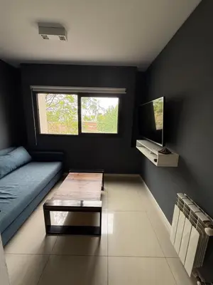 a living room with a bed and a coffee table at Departamento - Complejo Casonas de Manantiales in Cordoba