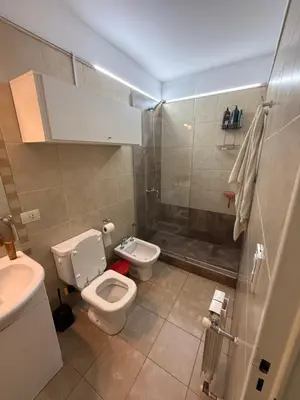 a bathroom with a toilet and a sink and a shower at Departamento - Complejo Casonas de Manantiales in Cordoba