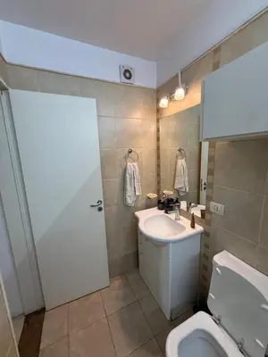 a bathroom with a white sink and a toilet at Departamento - Complejo Casonas de Manantiales in Cordoba