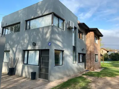 a gray house with a brick at Casa de categoría in Santa Rosa de Calamuchita