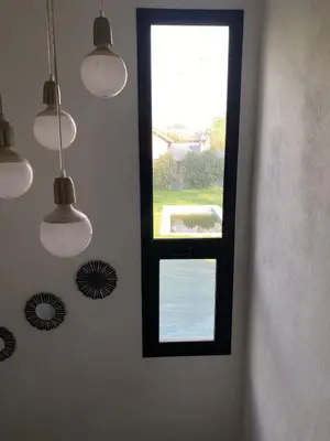 a window in a room with lights on the wall at Casa de categoría in Santa Rosa de Calamuchita