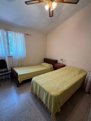 a bedroom with two beds and a ceiling fan at Casa 7 Cajones in Trapiche