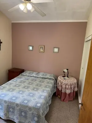 a bedroom with a bed and a small table at Casa 7 Cajones in Trapiche