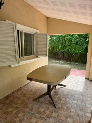 a table in the corner of a room with two windows at Casa 7 Cajones in Trapiche