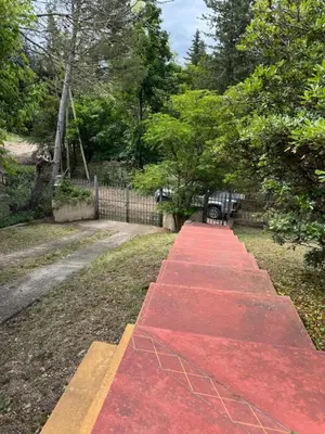 a red walkway in a park with a fence at Casa 7 Cajones in Trapiche