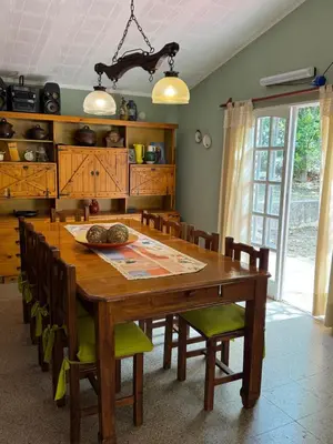 a dining room with a wooden table and chairs at Casa 7 Cajones in Trapiche