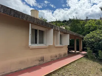 a house with white windows on the side of it at Casa 7 Cajones in Trapiche