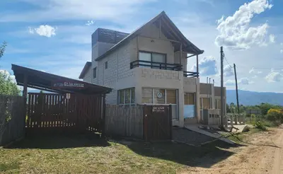 a house with a fence in front of it at En Las Sierras - Departamento de Montaña in Villa Yacanto