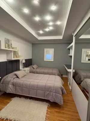 a bedroom with two beds and a ceiling at Casa minimalista con vistas a las sierras in Villa Carlos Paz