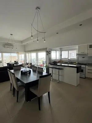 a kitchen with a table and chairs in a room at Casa minimalista con vistas a las sierras in Villa Carlos Paz