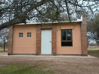 a small brick house with a white door at El Parador in Las Bajadas