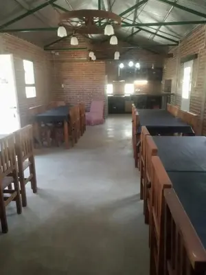 a large room with tables and chairs in it at El Parador in Las Bajadas