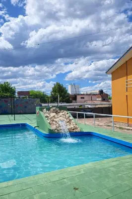 a pool with a water slide in a building at KIN Hotel in Villa Carlos Paz