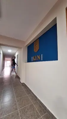 a man walking down a hallway in a building at KIN Hotel in Villa Carlos Paz