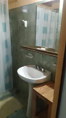 a bathroom with a sink and a mirror at Camino de Santidad in Piedras Blancas