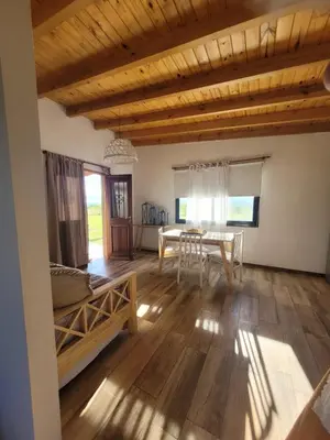 a living room with a table and a dining room at Brisas De Las Sierras in Villa Ciudad Parque
