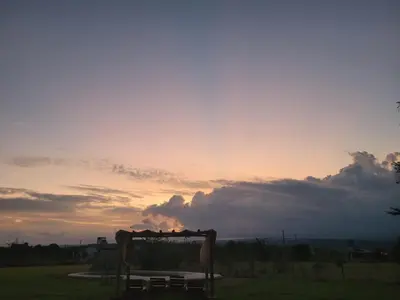 a bench in a field with a sunset in the background at Brisas De Las Sierras in Villa Ciudad Parque