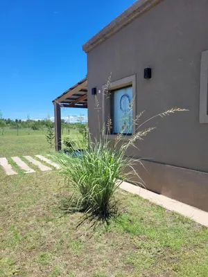 a building with a window with a clock on it at Brisas De Las Sierras in Villa Ciudad Parque