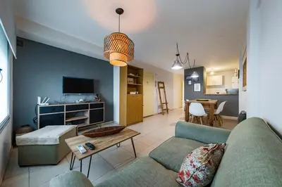 a living room with a couch and a table at Gral Paz con patio privado y asador in Cordoba