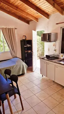 a kitchen with a bed and a table in a room at Rohvolk chill aparts in Villa General Belgrano