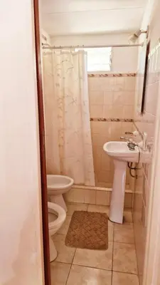 a small bathroom with a toilet and a sink at Rohvolk chill aparts in Villa General Belgrano