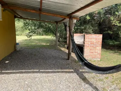 a porch with a hammock under a roof at cabañas Gerom in Pantanillo
