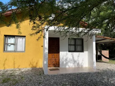 a small yellow and white house with a door at cabañas Gerom in Pantanillo
