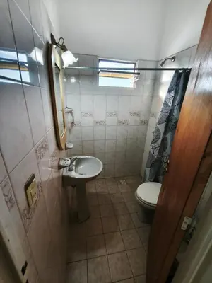 a small bathroom with a toilet and a sink at Dpto Villa Carlos Paz max 5 personas