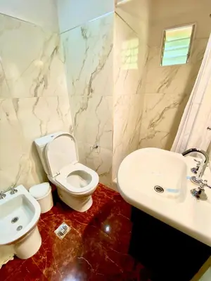 a bathroom with a toilet and a sink at La Ribera Aparts in Santa Rosa de Calamuchita