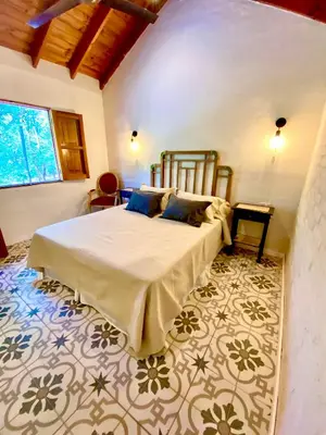 a bedroom with a large bed in a room at La Ribera Aparts in Santa Rosa de Calamuchita