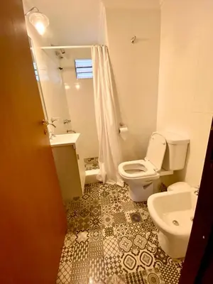 a bathroom with a toilet and a sink at La Ribera Aparts in Santa Rosa de Calamuchita