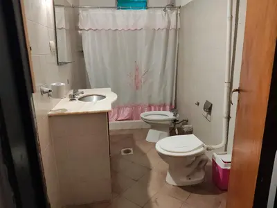 a bathroom with a toilet and a sink and a shower at Departamentos sandry in Villa Carlos Paz