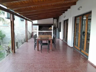 a patio with a table and chairs on it at La Morada de tus Sueños VCP con vista al LAGO in Villa Carlos Paz