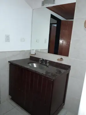 a bathroom with a sink and a mirror at La Morada de tus Sueños VCP con vista al LAGO in Villa Carlos Paz
