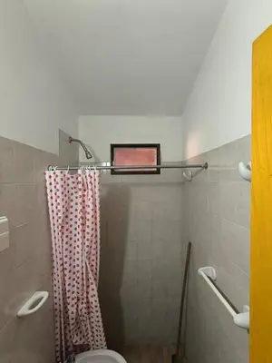 a bathroom with a shower with a toilet and a window at Sweet Angel in Villa Cura Brochero