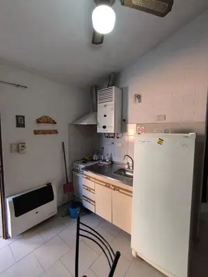 a kitchen with a white refrigerator and a sink at Sweet Angel in Villa Cura Brochero