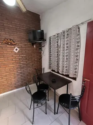 a dining room with a table and chairs and a tv at Sweet Angel in Villa Cura Brochero