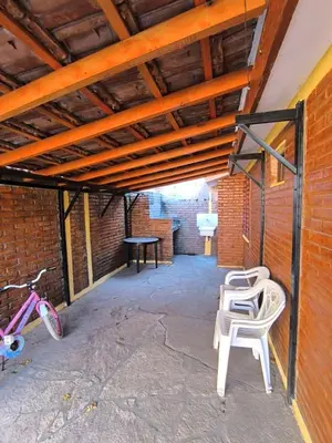 a patio with a table and chairs and a bike at Sweet Angel in Villa Cura Brochero