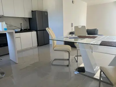 a kitchen with a glass table and two chairs at Departamento en Nueva Córdoba, Córdoba Capital in Cordoba